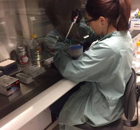 Woman in lab pipetting