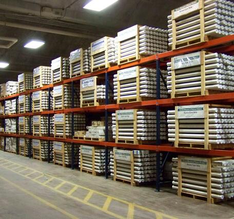 The image is of a warehouse with racks containing pallets of rock cores.