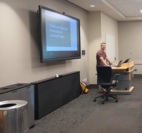 A CPWSC staff member giving a presentation on recent updates to internal data-management systems with the goal of improving efficiency, reliability, and consistency of data produced by USGS.