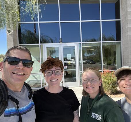 Four people smile in front of a Bureau of Land Management office in Phoenix, Arizona