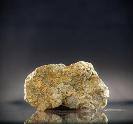 High-definition image showing granular texture and metallic flecks.