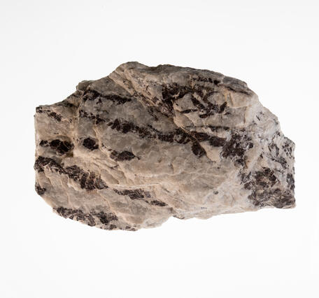 Graphite in Pegmatite, USGS mineral specimen of graphite crystals in pegmatite rock.