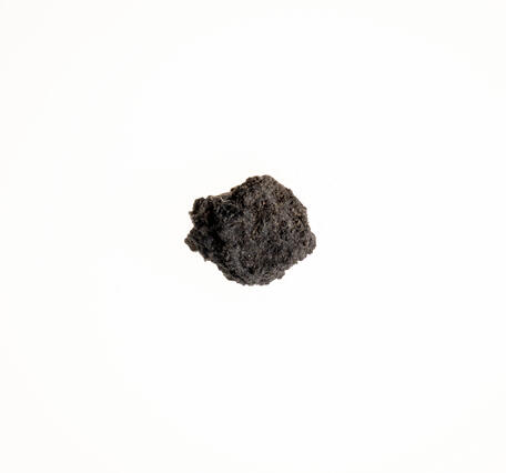 High-definition image of graphite lump specimen showing layered texture and dark gray color.