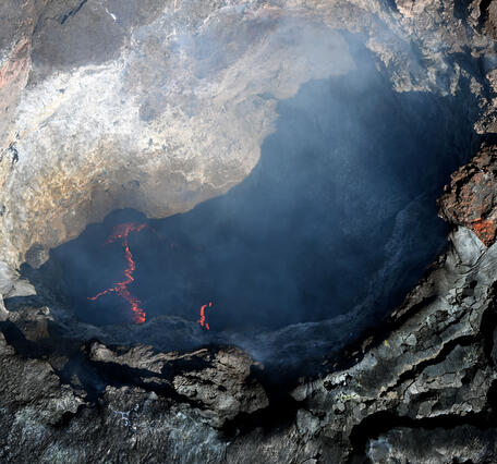 Color photograph of volcanic vent with lava 