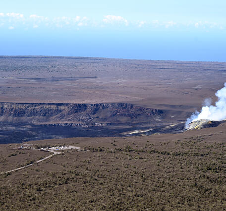 Color photograph of degassing volcanic vents within crater
