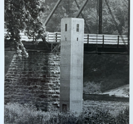Looking at the gage house next to the bridge