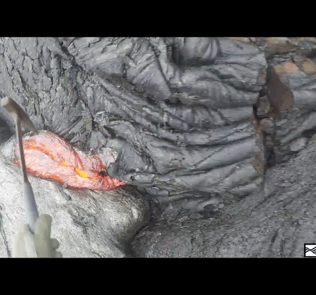 A repeating loop showing a hammer scooping lava from a flow and dropping it into a bucket.