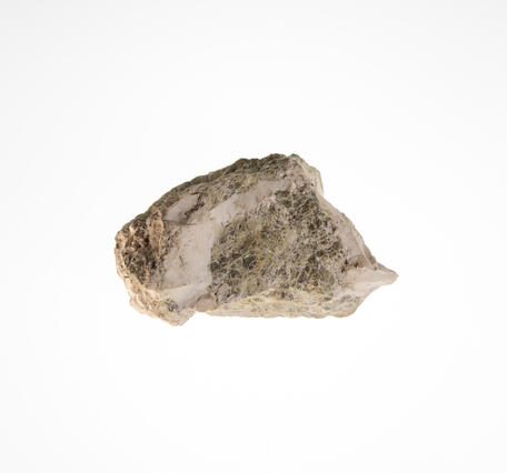 High-definition image of magnesite specimen with earthy texture and white-gray tones.