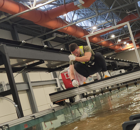 A Hydrologic Technician applies his field sampling expertise to laboratory experiments aboard the HIF tilting flume.