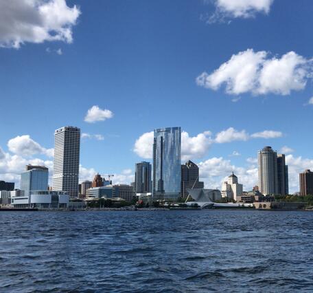 View of Milwaukee, Wisconsin city skyline with water in foreground