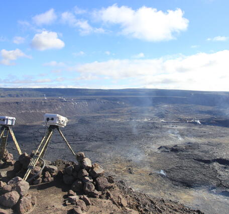 Color photograph of caldera and webcams perched on rim