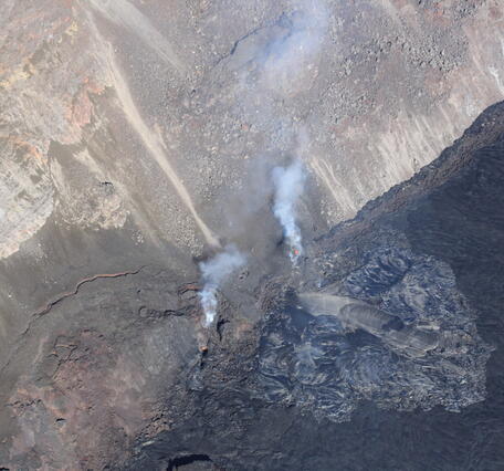 Color photograph of lava flows at base of crater