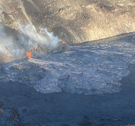 Color photograph of erupting vents and lava flows