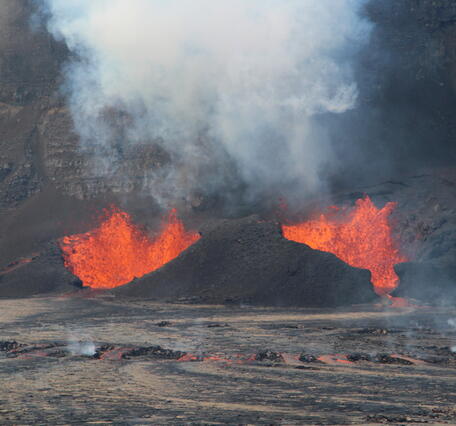 Color photograph of vents erupting lava