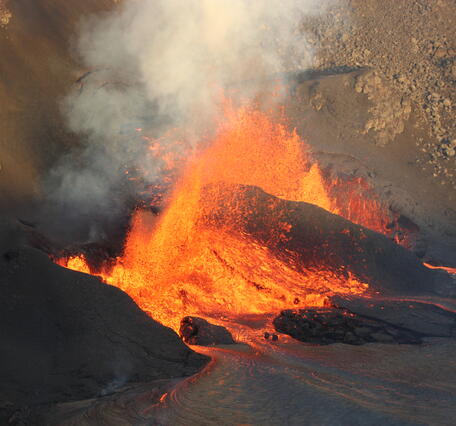 Color photograph of volcanic vents erupting lava