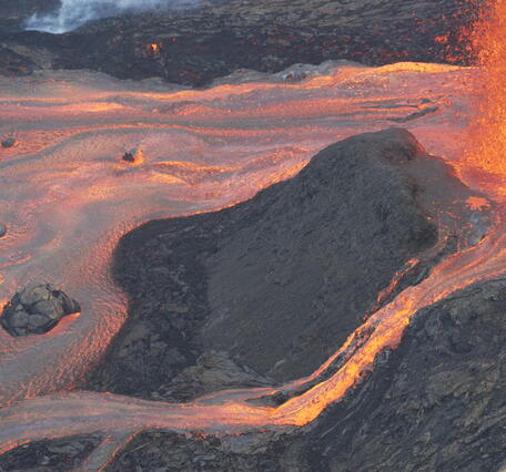 Color photograph of lava flows from volcanic vent