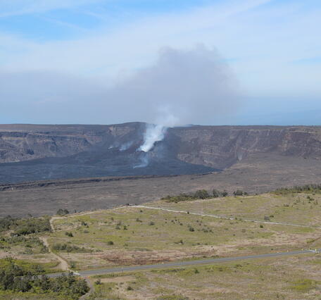 Color photograph of caldera with degassing vent within