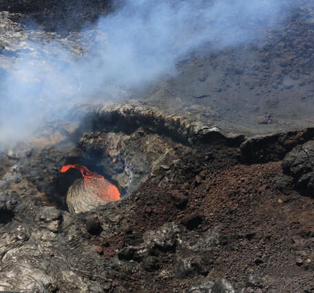 Color photograph of lava pond in volcanic vent