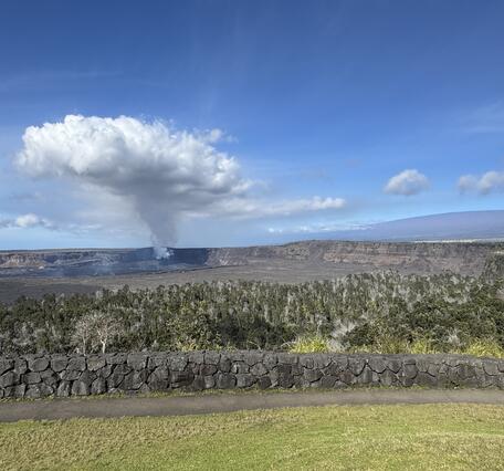 Color photograph of degassing plume above caldera