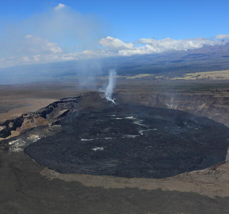 color photo of the Kaluapele with the steaming vents in the distance. 