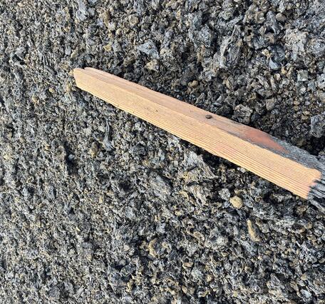 Color photograph of damaged post