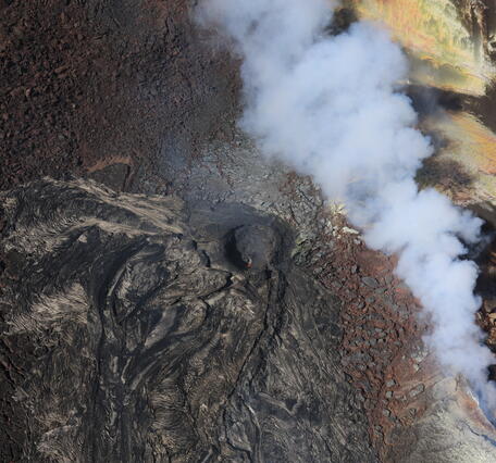 Color photograph of volcanic vent that is degassing