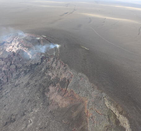 Color photograph of cliff covered with slumping volcanic deposits