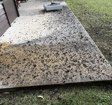 Color photograph of volcanic rocks on a cement pad