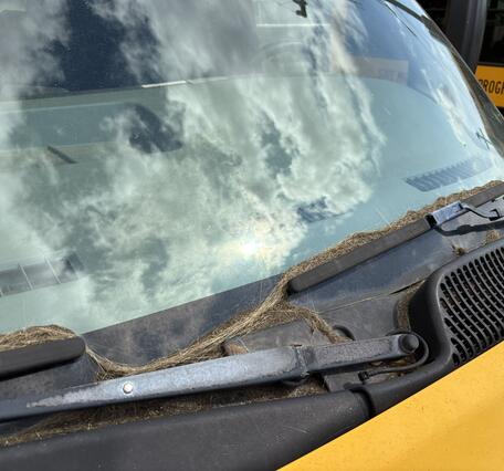 Color photograph showing volcanic material accumulated on vehicle