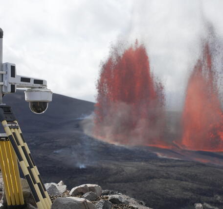 Color photograph of lava fountains and camera