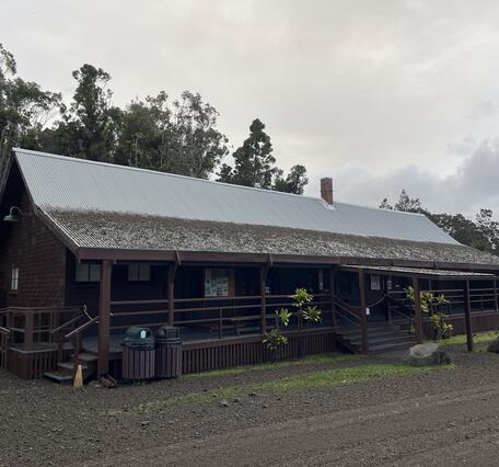 Color photograph of roof partially covered with volcanic fallout