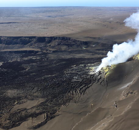 Color photograph of volcanic vents degassing within crater