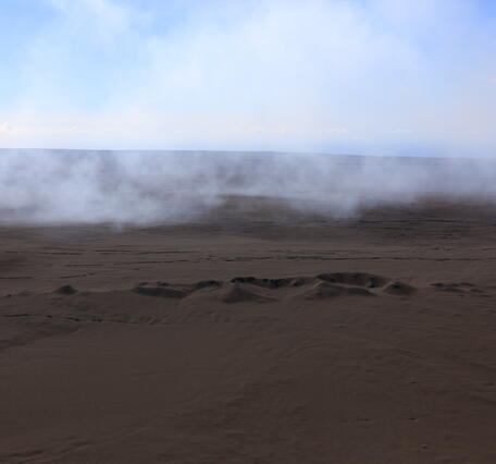 Color photograph of volcanic landscape blanketed with fallout from lava fountains