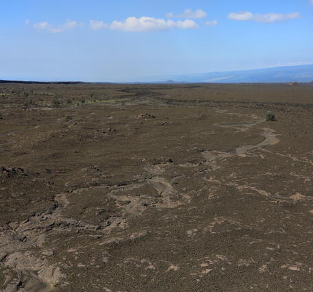 Color photograph of volcanic landscape with eroded tephra deposits