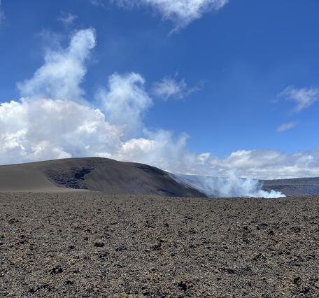 Color photograph of volcanic cone and volcanic degassing