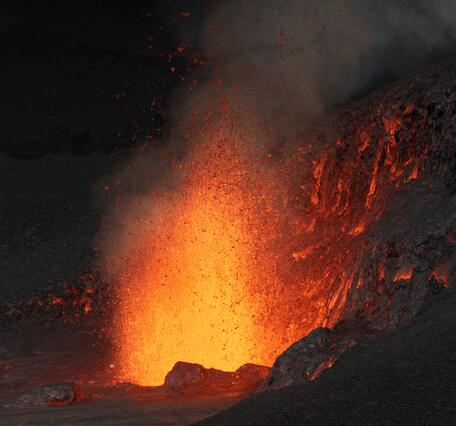 Color photograph of lava fountain at night