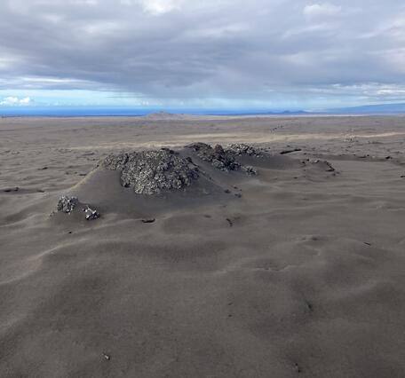 Color photograph of volcanic vent covered with tephra 