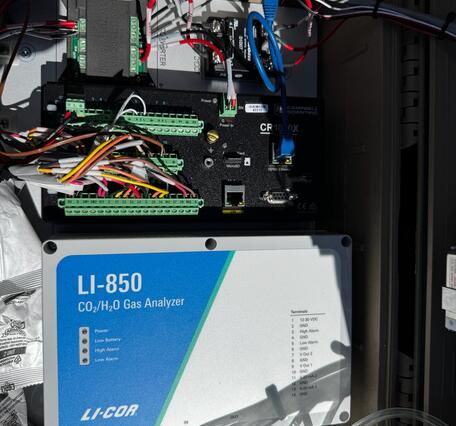Color photograph of electronics and cords in a box