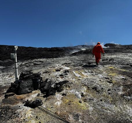 Color photograph of volcanic degassing area with monitoring instrumentation