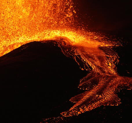 Color photograph of lava flow at night