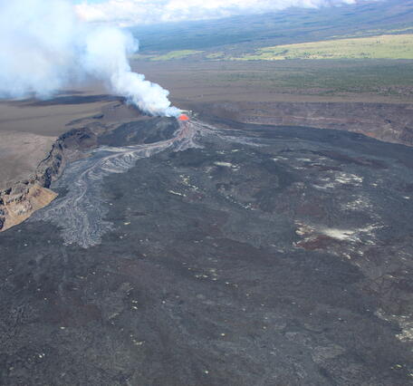 Color photograph of volcanic eruption within caldera