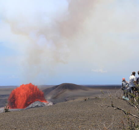 Color photograph of lava fountain and viewers