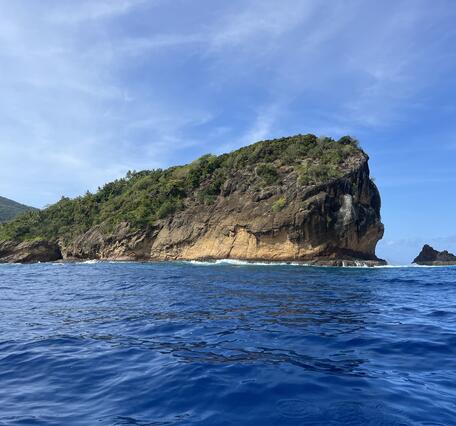 Color photograph of island rising from ocean