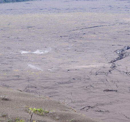 Color photograph of steaming ground cracks