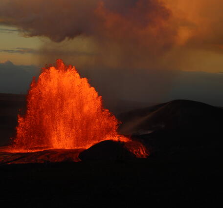 Color photograph of lava fountain at sunrise