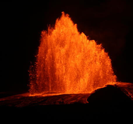 Color photograph of lava fountain at night