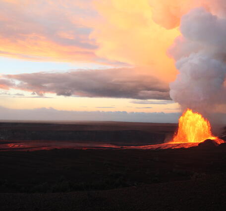 Color photograph of lava fountaining during sunrise