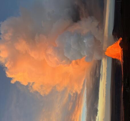 Color photograph of lava fountain at sunrise