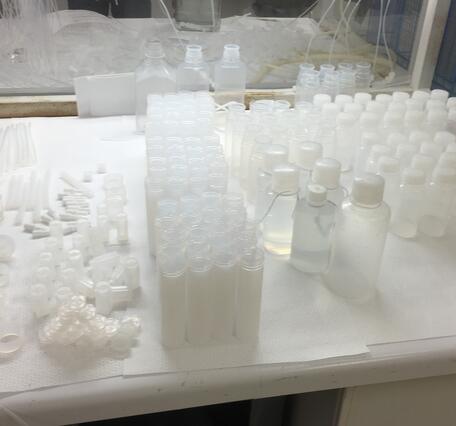 An assortment of white plastic Teflon sample bottles 