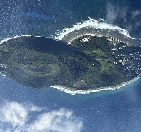 Color photo looking down at Aunu‘u Island from the air during a flight. 